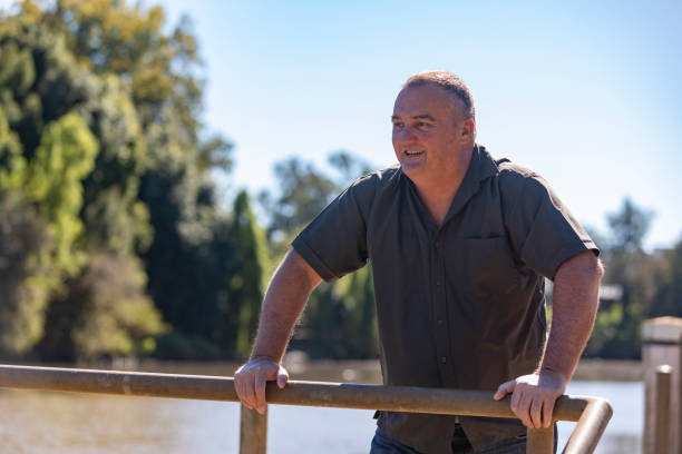 istock Happy Middle Aged Man Smiling by a River 1318783302