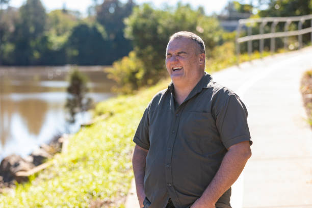 istock Happy Middle Aged Man Smiling by a River 1318783305