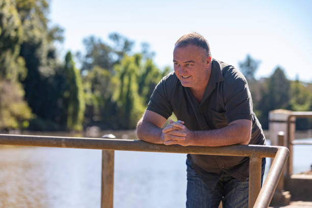 istock Happy Middle Aged Man Smiling by a River 1318783308