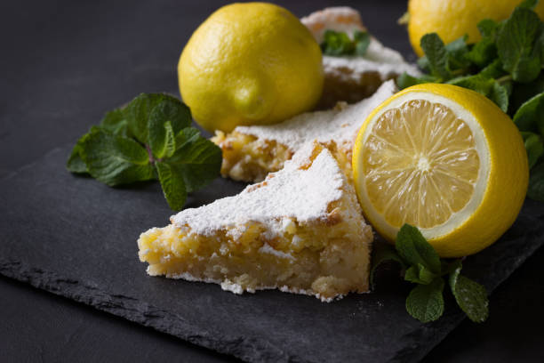 istock Lemon pie, lemons and mint leaves on dark background . 1318789856