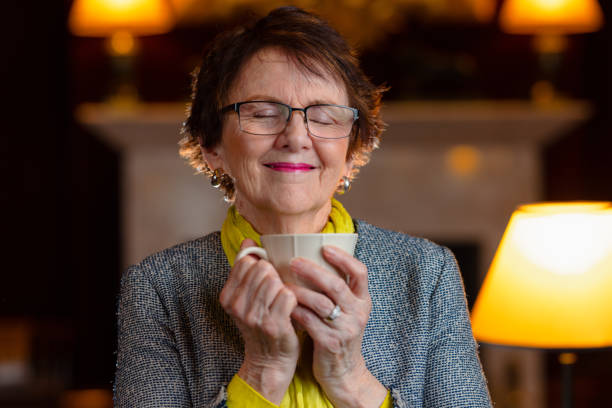 istock Smiling woman enjoying her coffee 1318791034