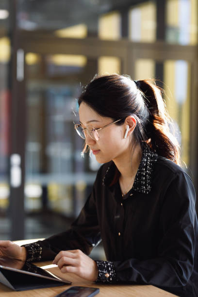 istock Young Professional Woman Working Wirelessly On Digital Tablet 1318791041