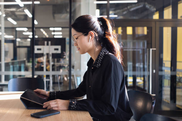 istock Young Professional Woman Working Wirelessly On Digital Tablet 1318791137