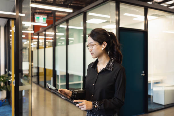istock Young Professional Woman With Digital Tablet In Modern Workspace 1318791168