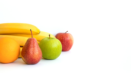 Banner. Fruits: banana, orange, apple and pear, isolated on a white background. Copy space