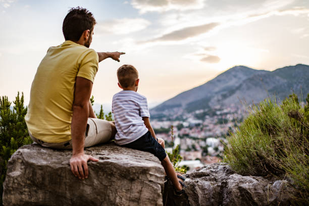 istock Young family relaxing in mountains at sunset 1318792591