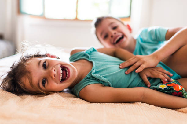 istock Beautiful children playing on the bed 1318792788