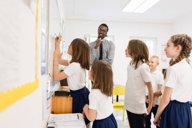 istock Primary School Teacher and students In Classroom 1318793663