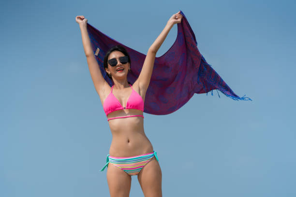 istock woman posing outdoors at the sea beach 1318794081