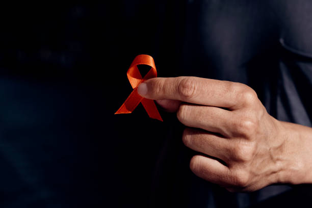 istock man with orange ribbon for multiple sclerosis 1318794343