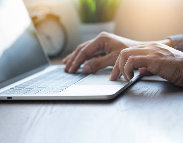 istock Close-up of man hands using and typing keyboard of laptop computer on office desk. Workspace, businessman working project creative idea for job online network. Business finance and technology concept. 1318796612