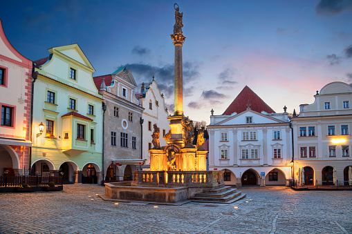 Cityscape image of main square of Cesky Krumlov with traditional architecture at twilight blue hour.
