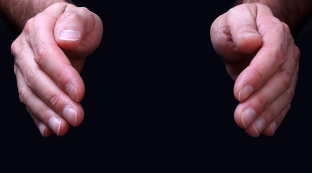 istock Hands with palms facing each other symbolize protection, on a black background 1318799532