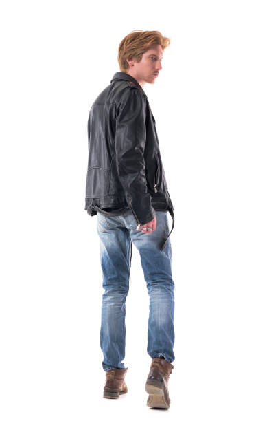 Back view of stylish young rocker man distracted turning behind Back view of stylish young rocker man distracted turning behind. Full body length isolated on white background turning back stock pictures, royalty-free photos & images