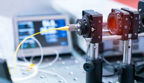 Experiment with laser device in optical laboratory Experiment with laser device in optical laboratory photon stock pictures, royalty-free photos & images