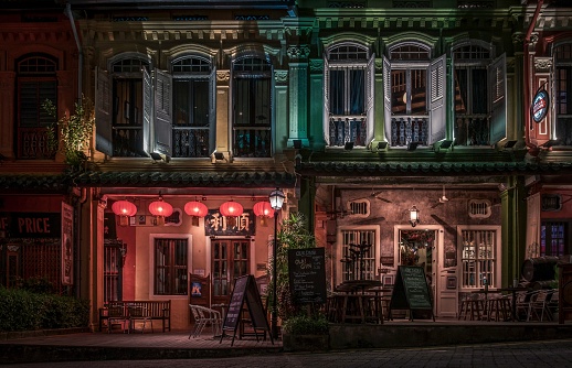 colourfully lit old houses at night time