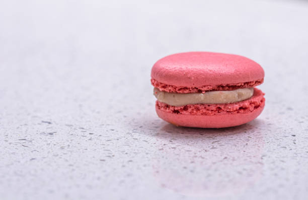 istock French cake macaron on white background. Tasty fruit, almond sweet cookie 1318803364