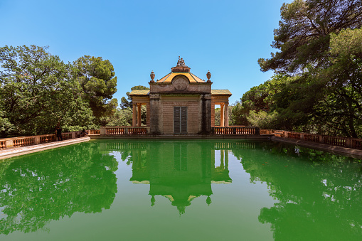 Green water pond in the Park of the Labyrinth of Horta (Parc del Laberint d'Horta) in Barcelona, Spain