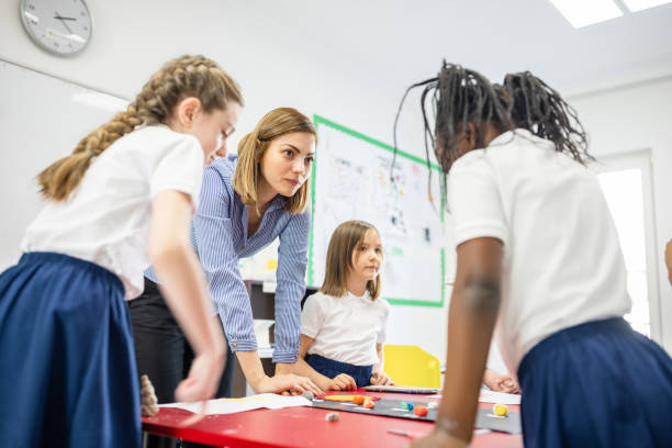 istock Primary School Teacher and Students In Classroom 1318805031