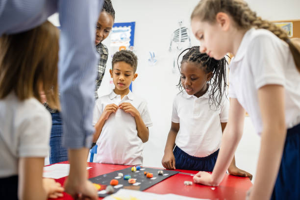 istock Primary School Teacher and Students In Classroom 1318805095