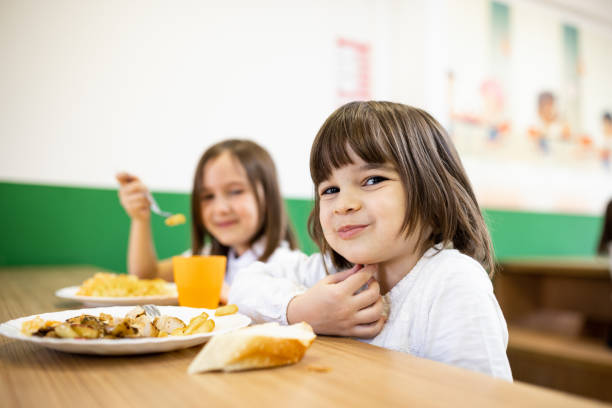 Primary school children on lunch break at school cafeteria Back to school. Primary school children having school lunch at school cafeteria food elementary student healthy eating schoolboy stock pictures, royalty-free photos & images