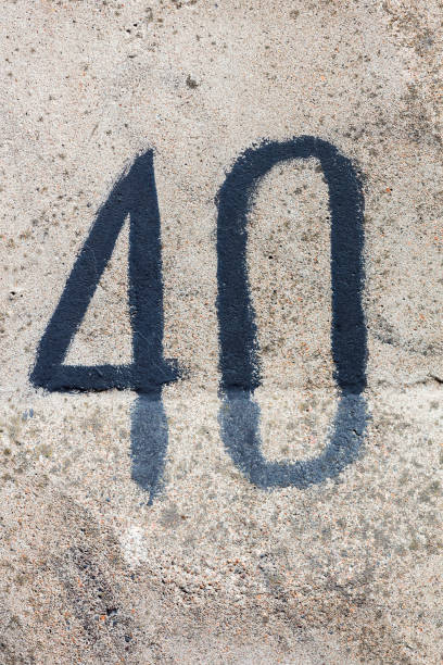 istock figure forty on a concrete wall. number on stone texture 1318808827