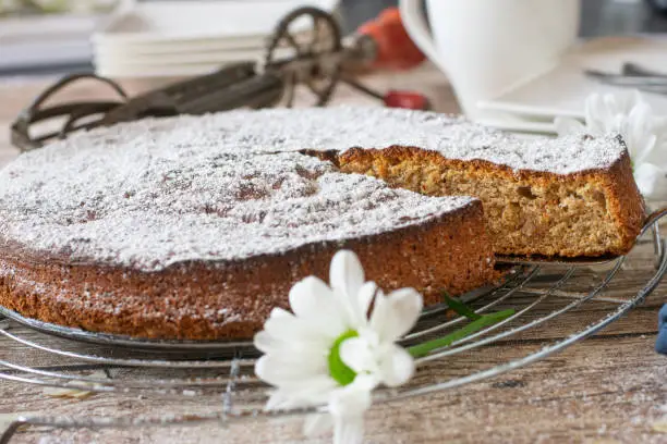Almond cake gluten free and fresh baked served on a rustic wooden table background. Spanish traditional recipe
