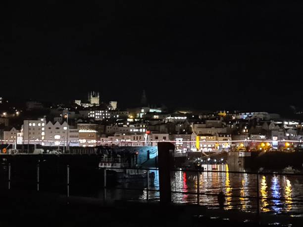 St peter port Town front Town at night from the view over the harbour guernsey city stock pictures, royalty-free photos & images