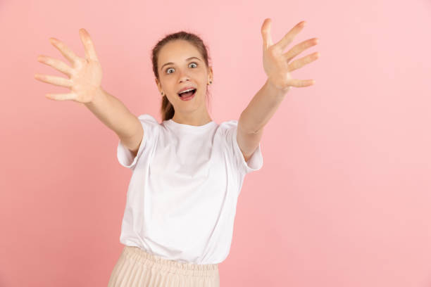 istock Caucasian young woman's portrait isolated over pink studio background with copyspace 1318812042