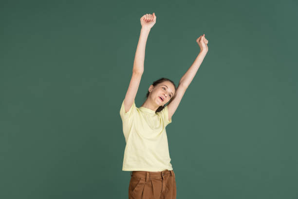 istock Caucasian young woman's portrait isolated over green studio background with copyspace 1318812274