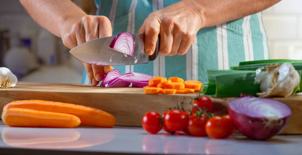 istock Woman chopping onion on chopping board 1318814393