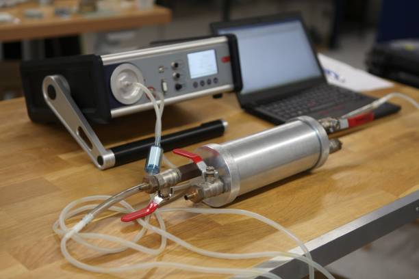 radon gas radiation detectors testing. dosimetrist holding a portable gamma radiation dosimeter set on a long tube with sample probe . - radium imagens e fotografias de stock