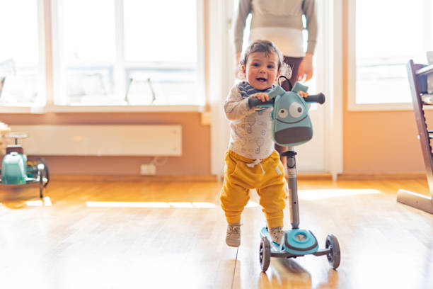 istock Boy having fun riding a scooter in living room 1318818223