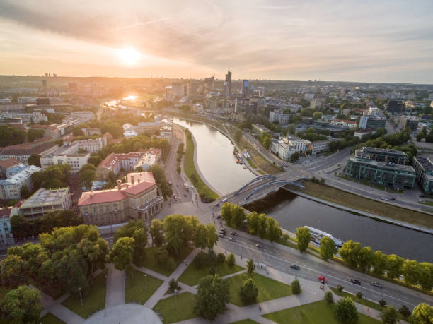 istock River Neris and Vilnius Business District in Background. Lithuania, Sunset Sky. 1318819220