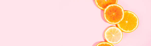 istock Colorful orange citrus slice fruit texture background on pastel pink 1318819870