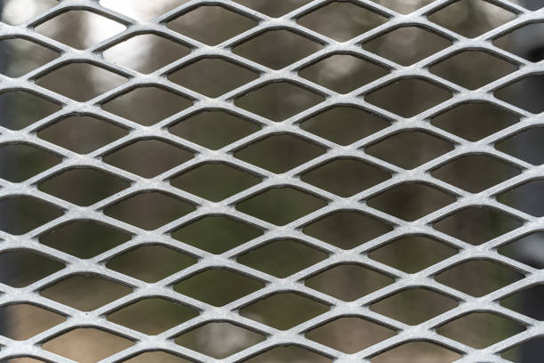 istock Metal mesh grid in weathered stained steel. Close up. 1318820983