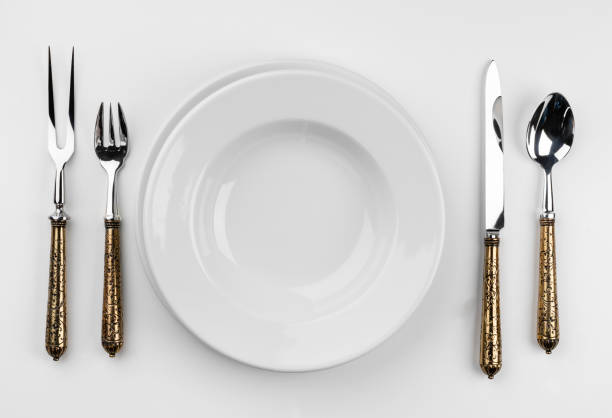 istock Empty plate with cutlery isolated on white background 1318821336