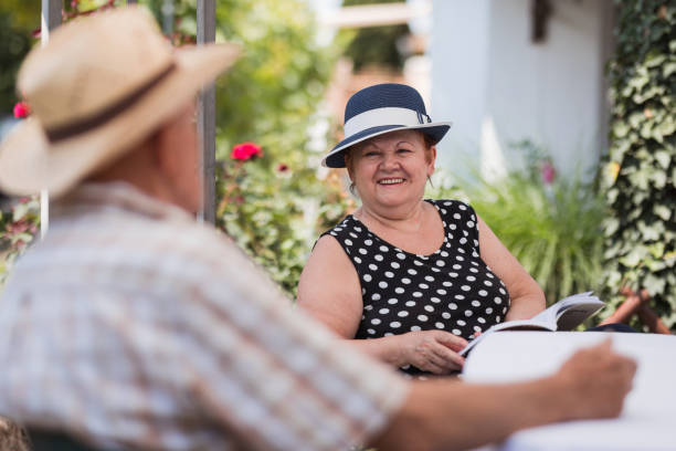 happy mature woman talking to a man - nostalgia joy laughing wellbeing imagens e fotografias de stock