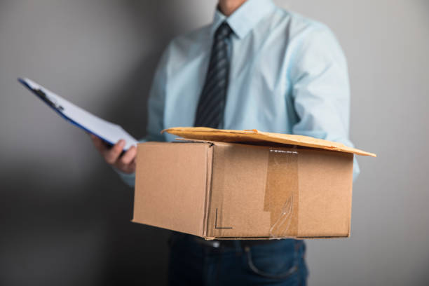 istock the courier holds the parcel and papers 1318823210