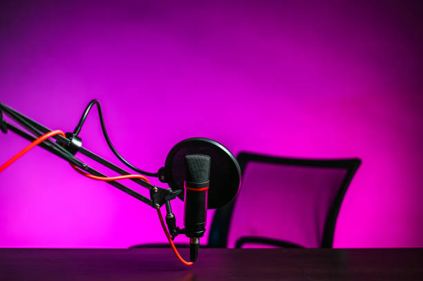 istock A microphone on the table and a pink backlit armchair. Video blogger workplace 1318825869