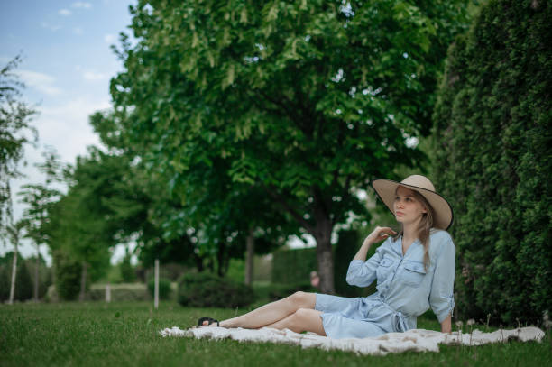 istock Romantic girl with hat on picnic in park 1318826113