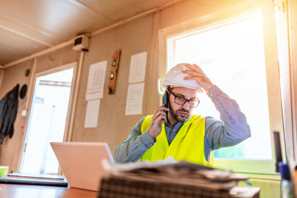 istock Male Engineer is anxious and strain about working while using smartphone in the office. 1318828526
