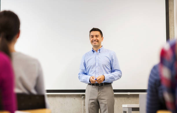 istock group of students and smiling teacher in classroom 1318829537
