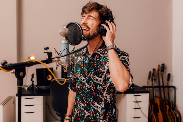 istock Young singer laying down tracks in a recording home studio 1318829547