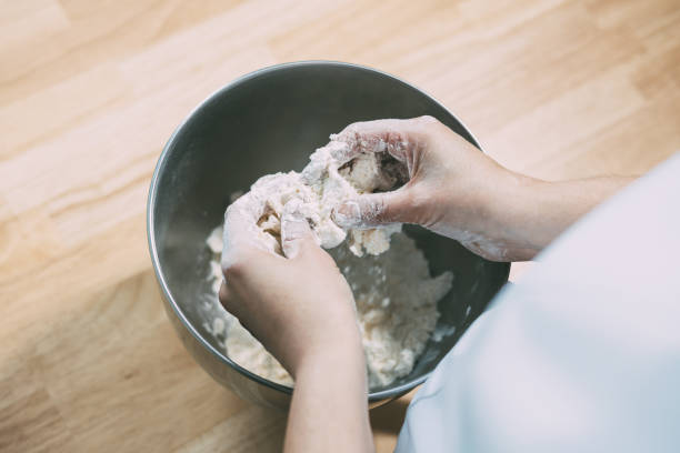 istock Professional pastry chef in the process of preparing a cake in her home kitchen 1318832084