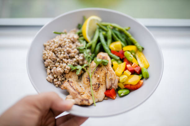 istock Hand holding a chicken and buckwheat dish with green beans 1318832220