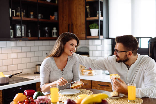 istock Happy couple having breakfast at home 1318833729
