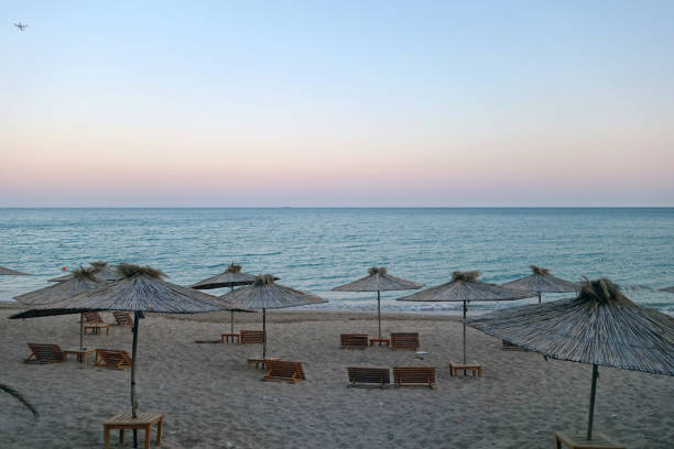 istock Beach view with straw umbrellas 1318835617