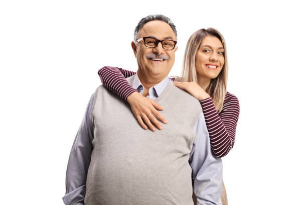 hija abrazando a su padre y sonriendo a la cámara - family adult portrait cheerful fotografías e imágenes de stock