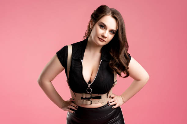 istock Sexy plus size model with large breasts on pink background 1318835906